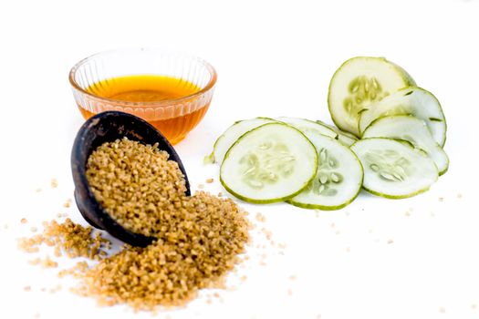 Cucumber face pack or face mask isolated on white with its entire ingredients which are oats and honey along with cucumber pulp well mixed in a glass bowl.Good for dry skin.