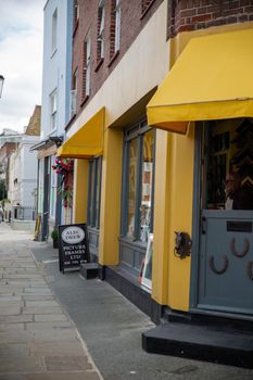 London, UK - February 14, 2020: Front side of Alec Drew Picture Frames LTD. Yellow framing shop from Notting Hill, London. Colorful London neighborhood