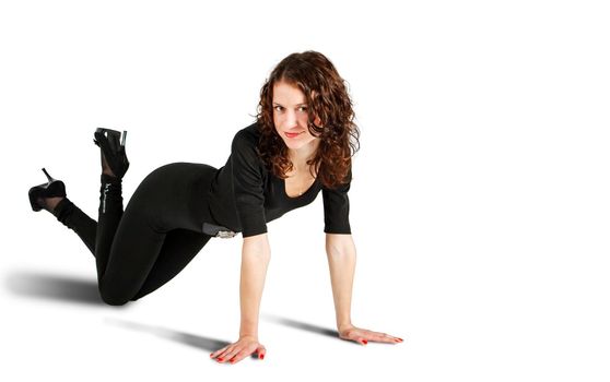 young beautiful woman in black suit posing standing on all fours in the studio on white background