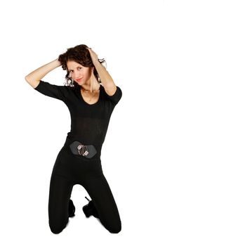 young beautiful woman in black suit posing in studio kneeling on white background