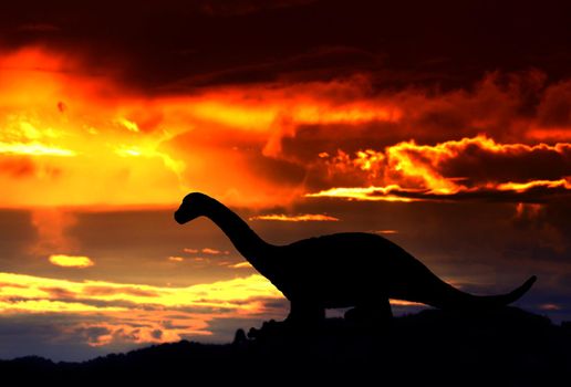 silhouettes of dinosaurs in the forest on sunset background with copy space add text