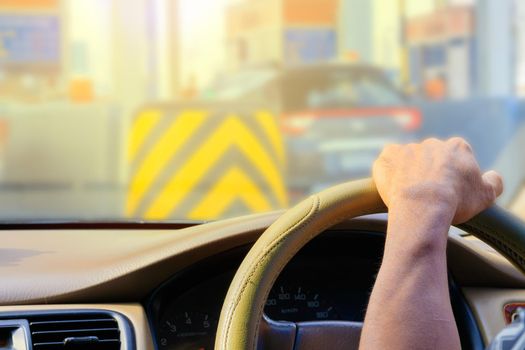 hand of man driving car travel on road Traffic jam and sunlight