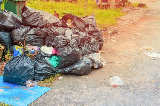 Pile garbage black bag plastic roadside in the city