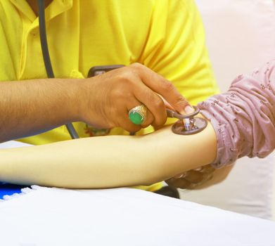physician checking health blood pressure on arm patient