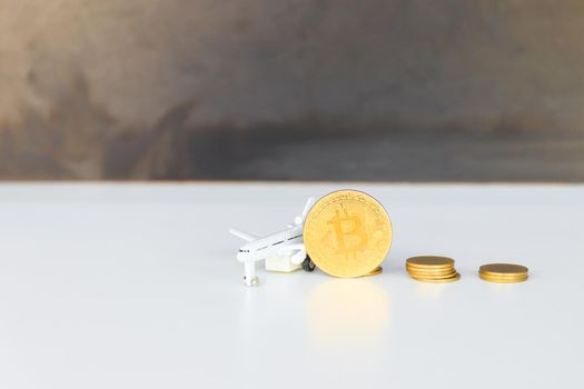 bitcoin coins and money stack and model of passenger plane  over white on black background. with copy space add text