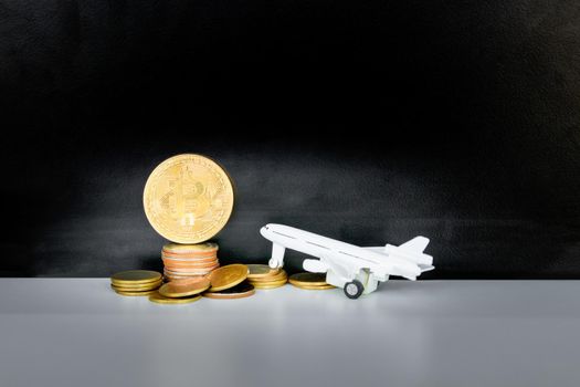 bitcoin coins and money stack and model of passenger plane  over white on black background. with copy space add text. color retro style