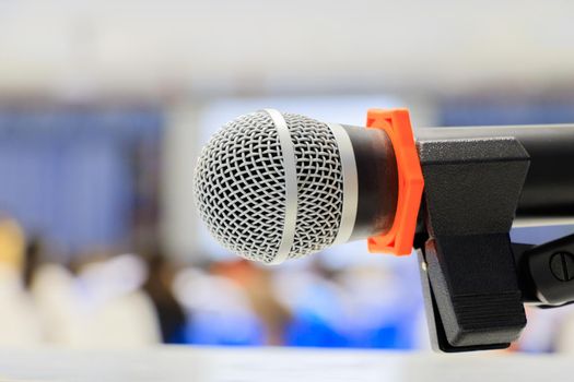 Close up microphone wireless old on Mic Stand in the conference and Background blur interior seminar meeting room