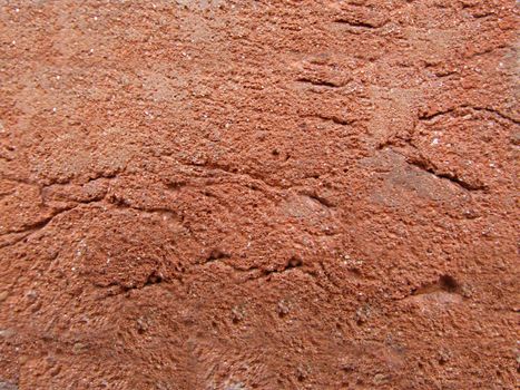 Decorative coating with cracks and roughness of red color.Texture or background