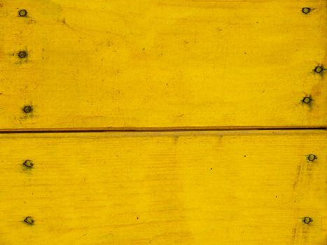 Old wooden and chipped board and painted yellow .Texture or background