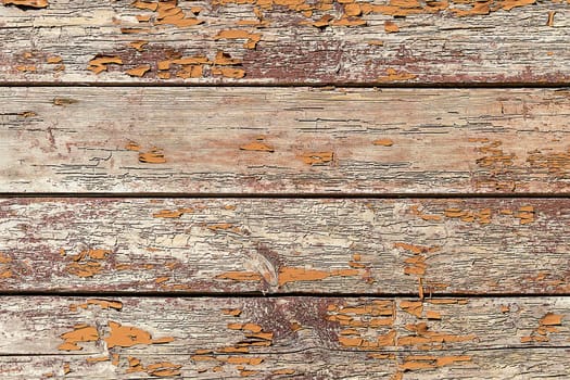 Wooden boards with a shabby orange paint background.