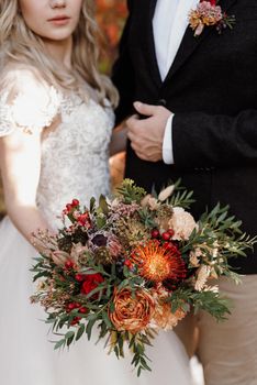 bridal bouquet in red autumn shades of Kenyan dried flowers