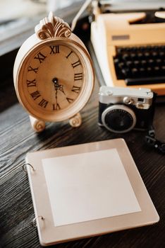 book of wishes made of wood next to the clock a camera with snapshots