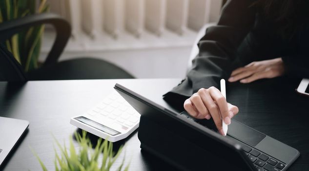 businesswoman use a digital tablet to check financial data..