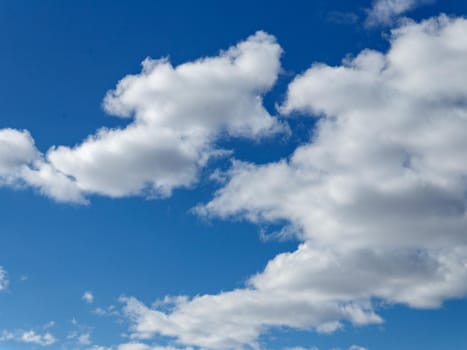 Light white clouds in blue sky on sunny spring day.