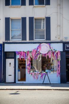 London, UK - February 14, 2020: Front side of Ask Mummy and Daddy candy store decorated with flowers. Flowered light blue candy shop. Colorful London neighborhood
