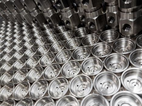 shiny steel industrial production parts after turning - close-up with selective focus