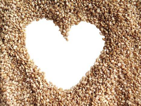 Sesame seeds in the form of heart on a white background