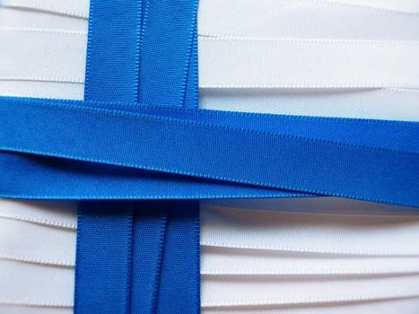 Finland flag or banner made with white and red ribbons