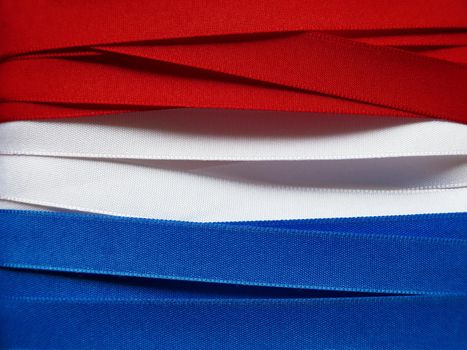 Luxembourg or Paraguay flag or banner made with red, blue and white ribbons