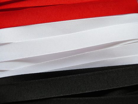 Iraq flag or banner made with red, white and black ribbons