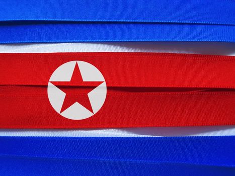 North Korea flag or banner made with red, blue and white ribbons