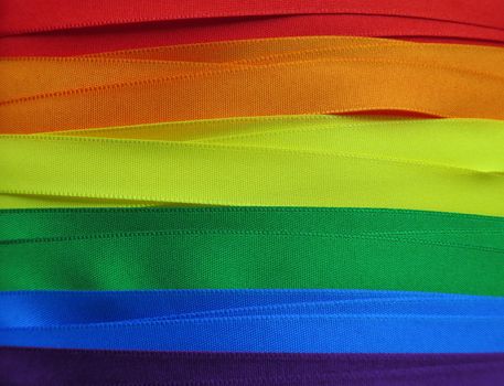 Gay Flag flag or banner made with red, orange, yellow, green, blue and purple ribbons