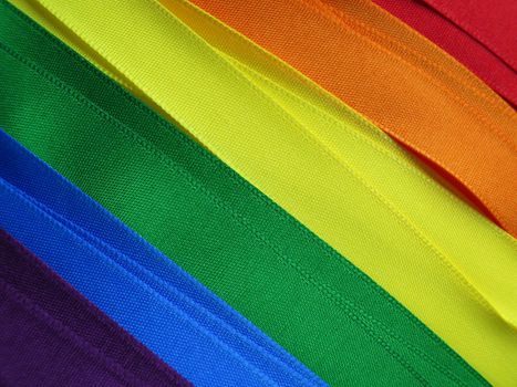 Gay Flag flag or banner made with red, orange, yellow, green, blue and purple ribbons