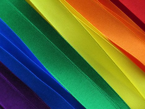 Gay Flag flag or banner made with red, orange, yellow, green, blue and purple ribbons