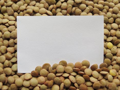 White tag on Heap of raw lentils background