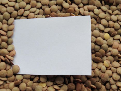 White tag on Heap of raw lentils background