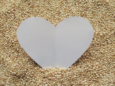 Heart shape on raw cous cous semolina background