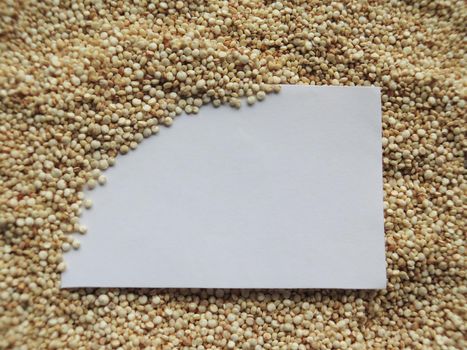 White paper on raw cous cous semolina background