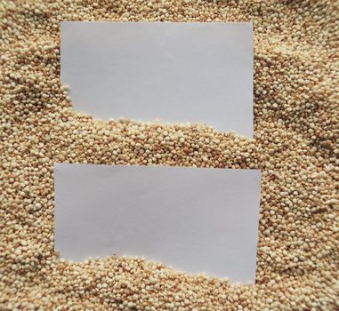 White paper on raw cous cous semolina background