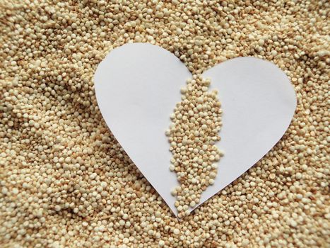 Heart shape on raw cous cous semolina background