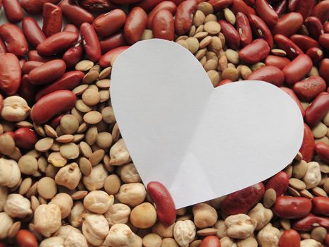 White Heart shape on Raw Red Beans, lentils and chickpeas Background. healthy food