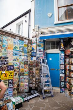 London, UK - February 14, 2020: Blue British music memorabilia shop in Notting Hill. Clothing and posters for sale outside colorful English building. Peaceful London neighborhood