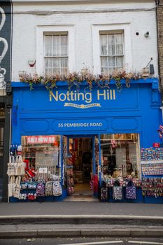 London, UK - February 14, 2020: Front side of blue souvenir store from Notting Hill, London. Blue English building decorated with flowers. Colorful London neighborhood