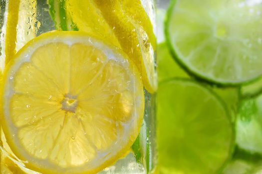 Cold refreshing homemade lemonade with mint, lemon and lime in mason jars.