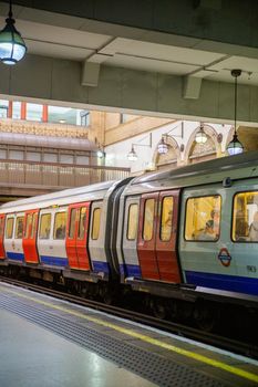 Train full of passengers inside London Underground station. Train in British subway station getting ready to go. Transportation in London