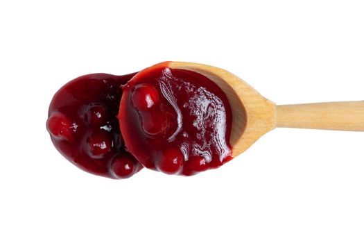 Homemade sauce made from fresh wild lingonberry drips from a spoon. Isolated on white background, top view.