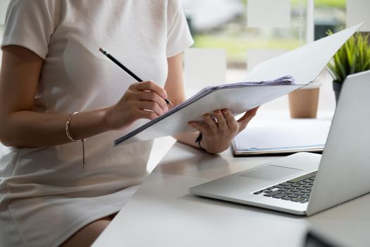 Audit working, Businessman work with paper document on clipping board in office.