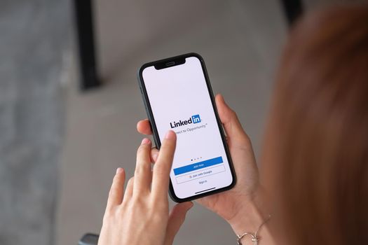 CHIANG MAI, THAILAND - APR 4, 2021: iPhone 12 with LinkedIn application on the screen. LinkedIn is a business-oriented social networking service.
