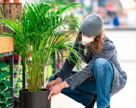 buying plants in a flowerpot in the garden center.