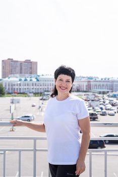 Sport and fitness. Senior sport. Active seniors. Smiling senior woman working out outdoors on urban background