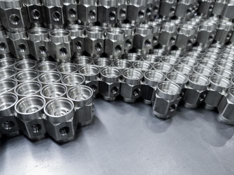 shiny steel industrial production parts after turning - close-up with selective focus
