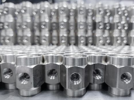 shiny steel industrial production parts after turning - close-up with selective focus
