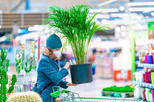 buying plants in a flowerpot in the garden center.