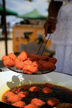 salvador, bahia / brazil - januuary 1, 2020: Acarejes are seen frying in dende azure in the city of Salvador.