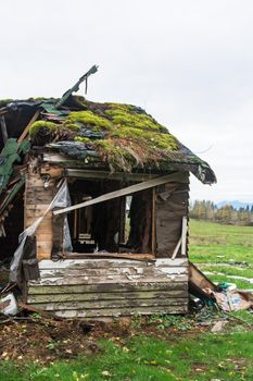 Old abandoned house in disrepair on cold fall day