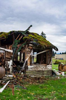 Old abandoned house in disrepair on cold fall day. Ruined house before final demolition